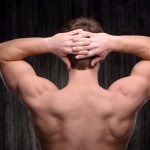 Close up of sporty man demonstrating back muscles